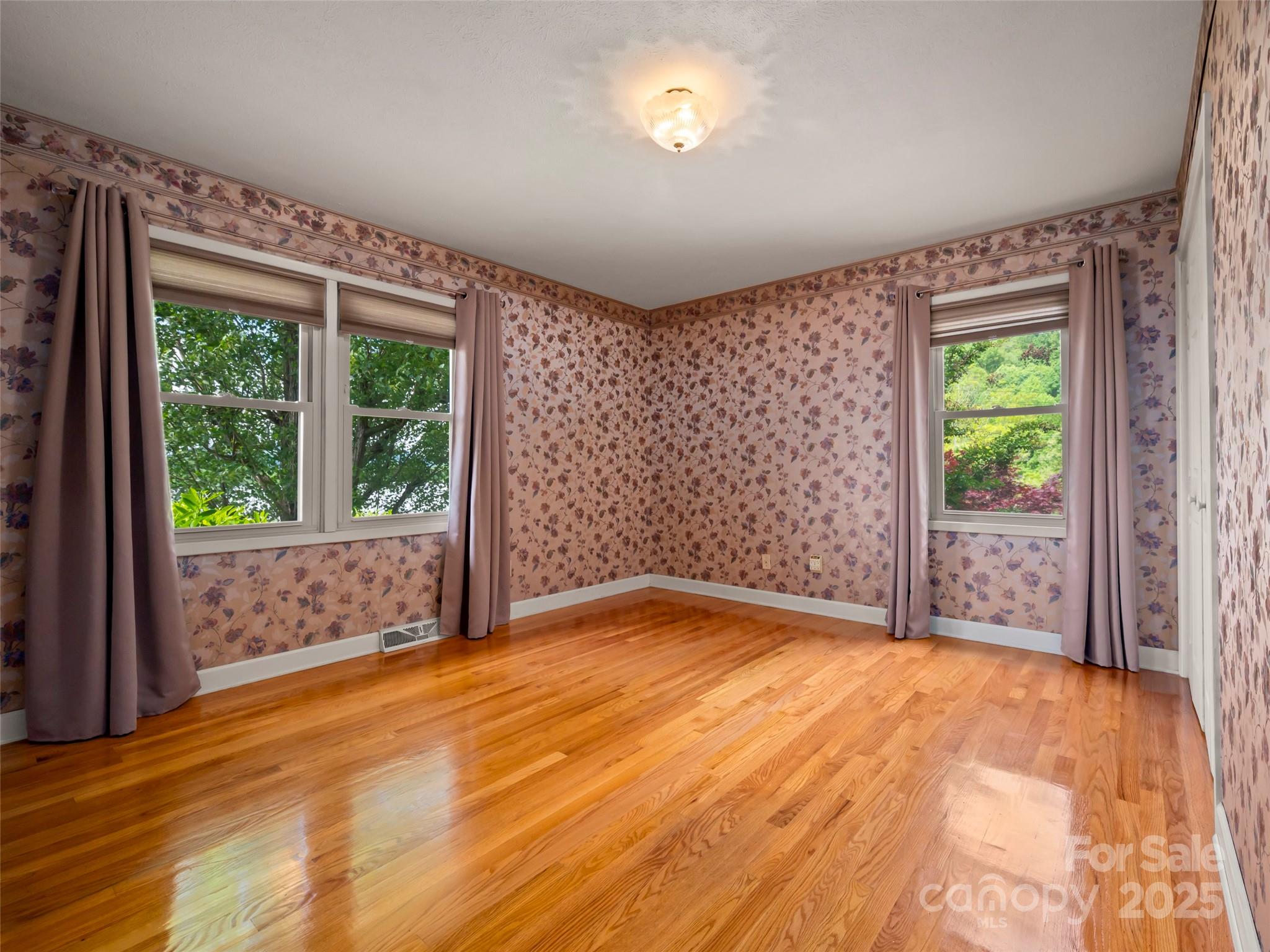 418 Mountain Page Road Saluda, NC 28773 - Photo 32 of 48 a view of an empty room with a window and wooden floor