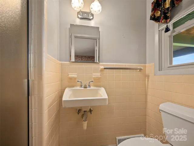 a bathroom with a sink toilet and mirror