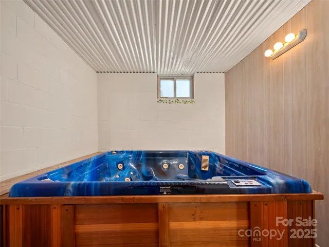 a bedroom with a bed and a lamp on the dresser