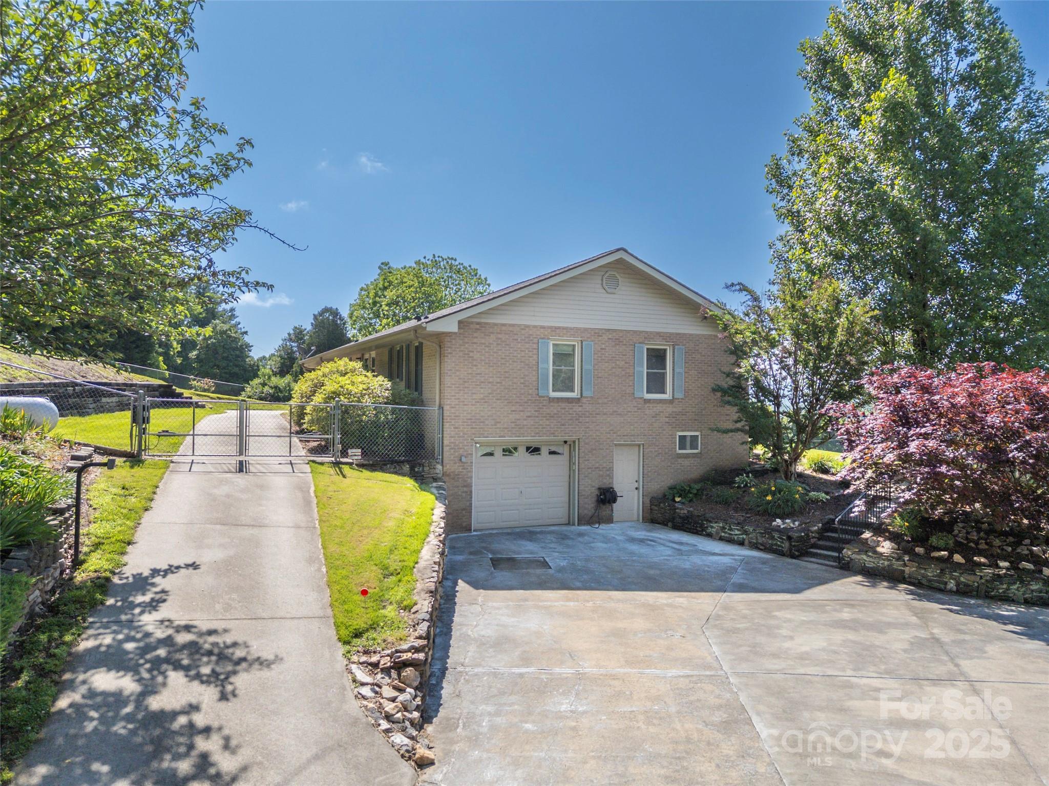 418 Mountain Page Road Saluda, NC 28773 - Photo 39 of 48 a view of a house with a yard and potted plants