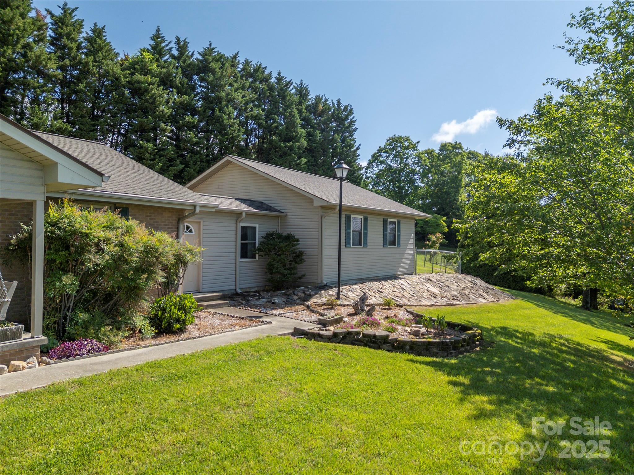 418 Mountain Page Road Saluda, NC 28773 - Photo 4 of 48 a view of a house with backyard and garden