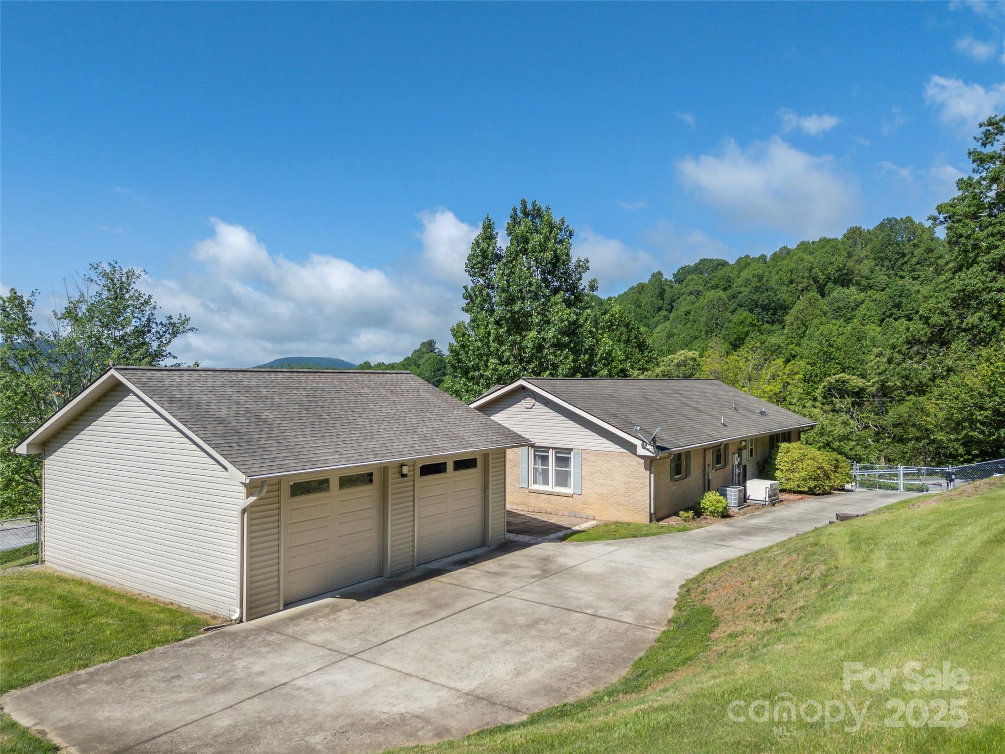 418 Mountain Page Road Saluda, NC 28773 - Photo 41 of 48 a front view of a house with a yard and garage