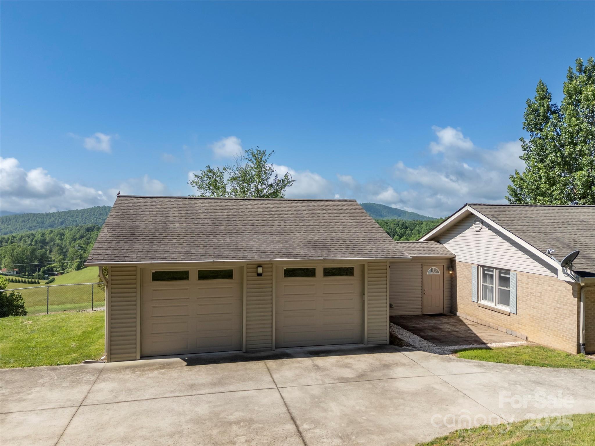 418 Mountain Page Road Saluda, NC 28773 - Photo 43 of 48 a front view of a house with a garage