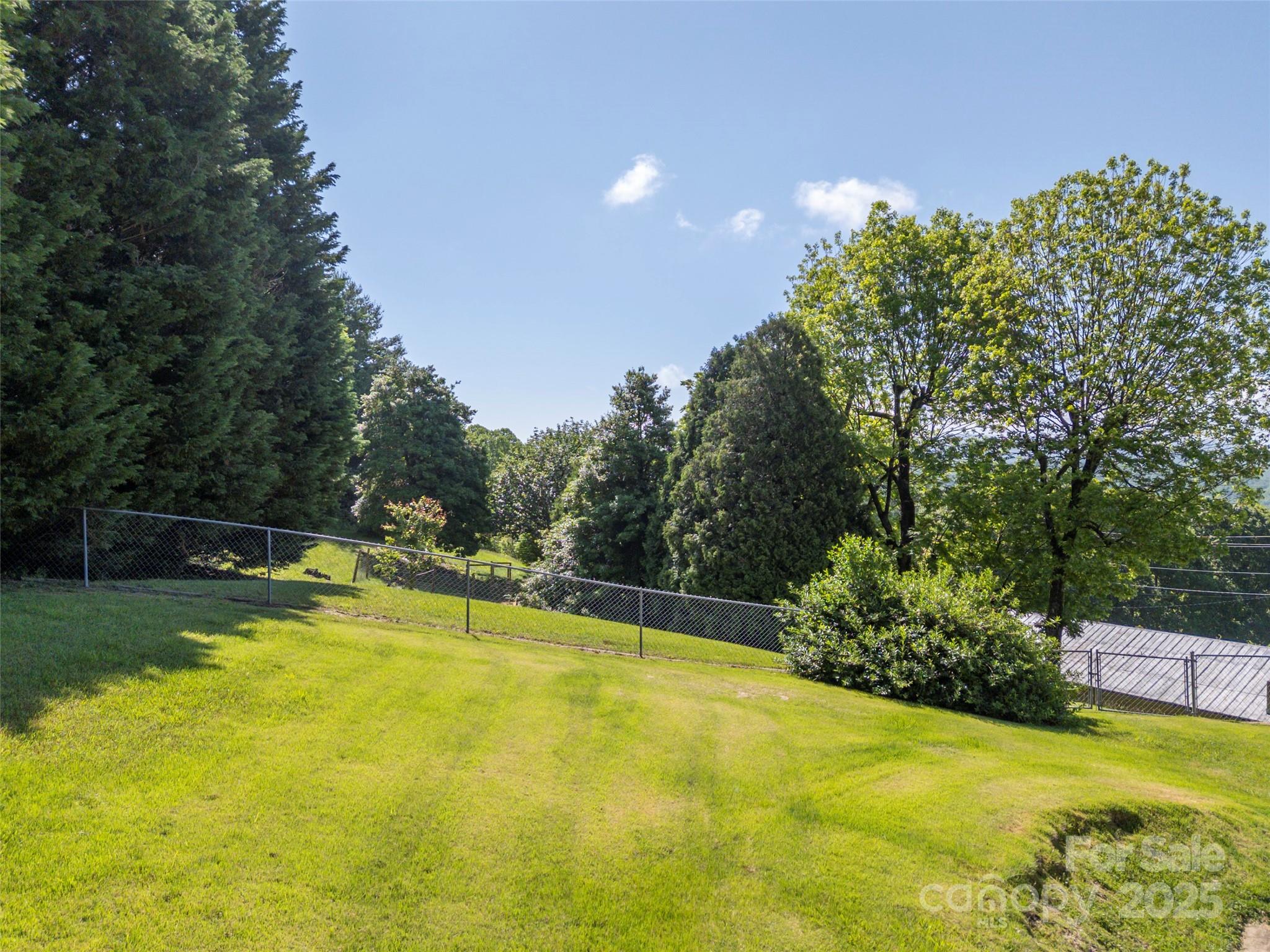 418 Mountain Page Road Saluda, NC 28773 - Photo 44 of 48 a view of a swimming pool with an outdoor seating and yard