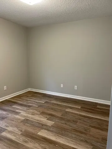 a view of an empty room and wooden floor
