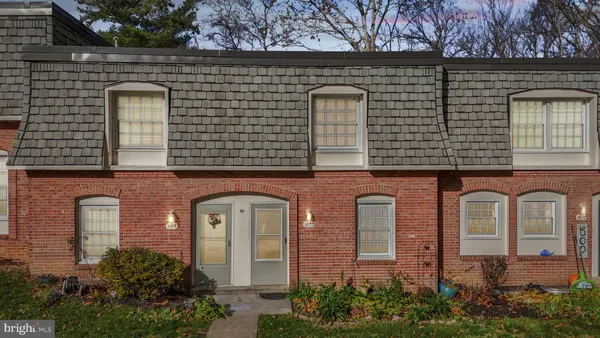 front view of a brick house with large windows
