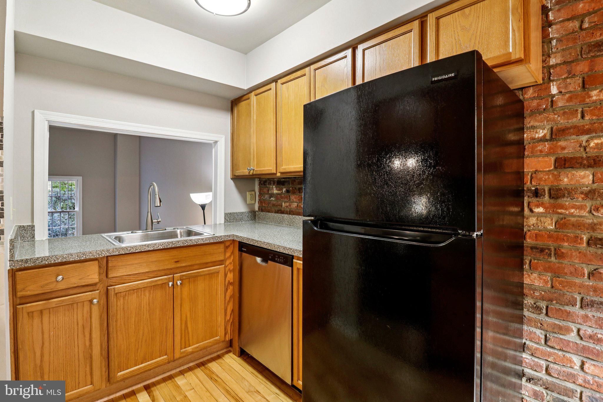5912 Minutemen Road, Unit 295 Springfield, VA 22152 - Photo 13 of 55 a kitchen with stainless steel appliances white cabinets and a granite counter tops