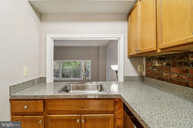 a kitchen with kitchen island a counter top space and a refrigerator