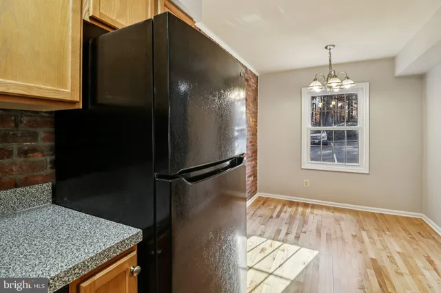 a kitchen with wooden cabinets and a stove top oven