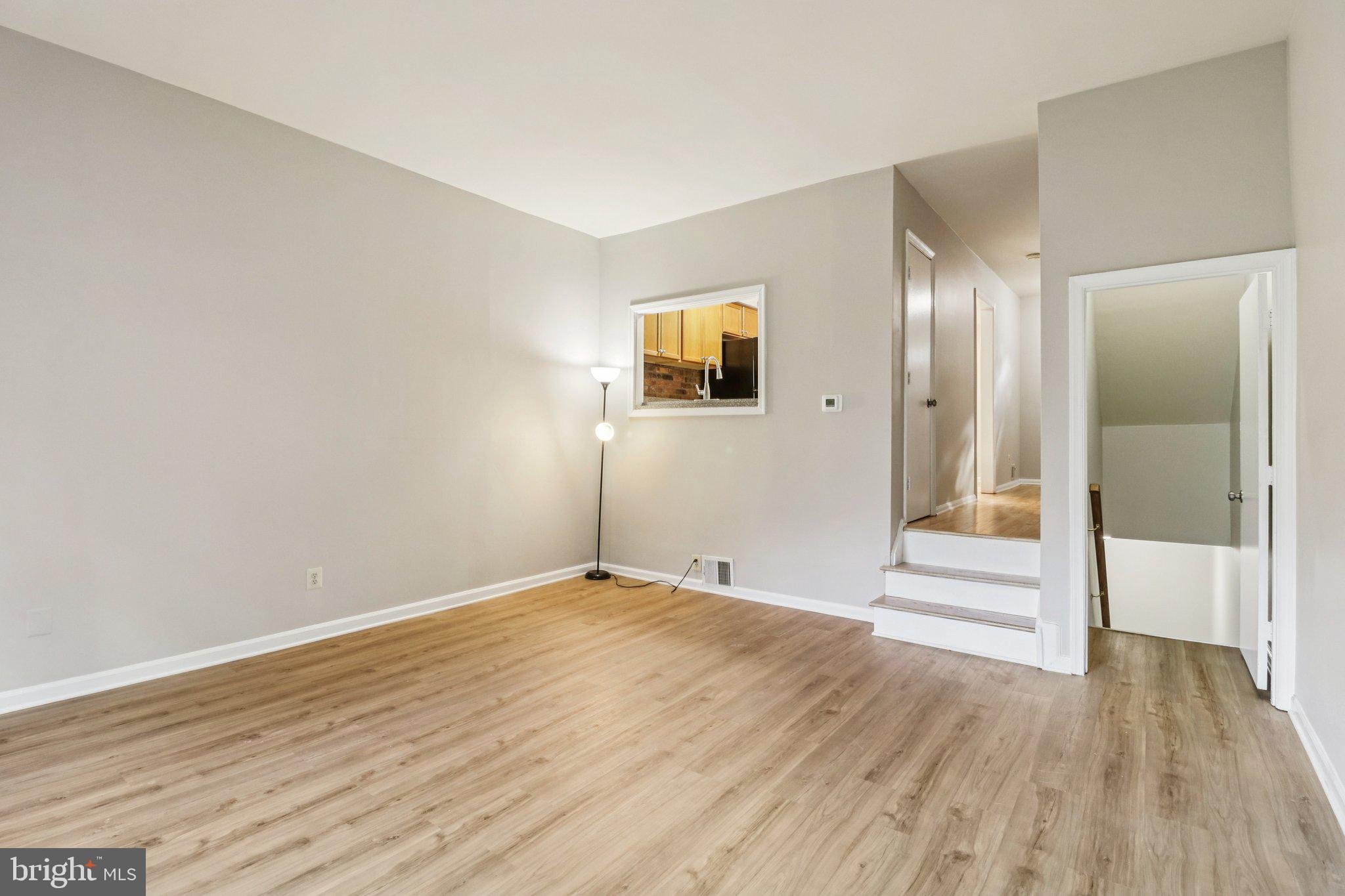 5912 Minutemen Road, Unit 295 Springfield, VA 22152 - Photo 22 of 55 an empty room with wooden floor and windows