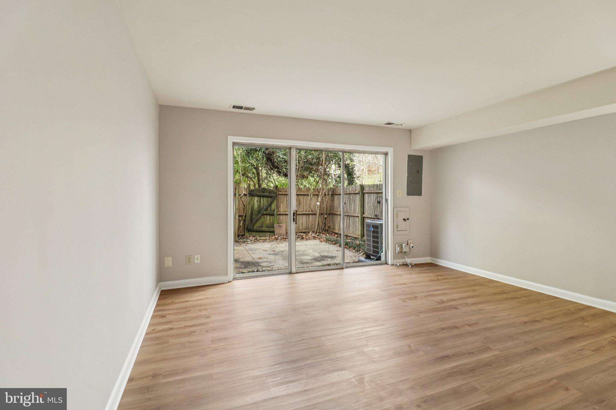 5912 Minutemen Road, Unit 295 Springfield, VA 22152 - Photo 23 of 55 a view of an empty room with wooden floor and a window