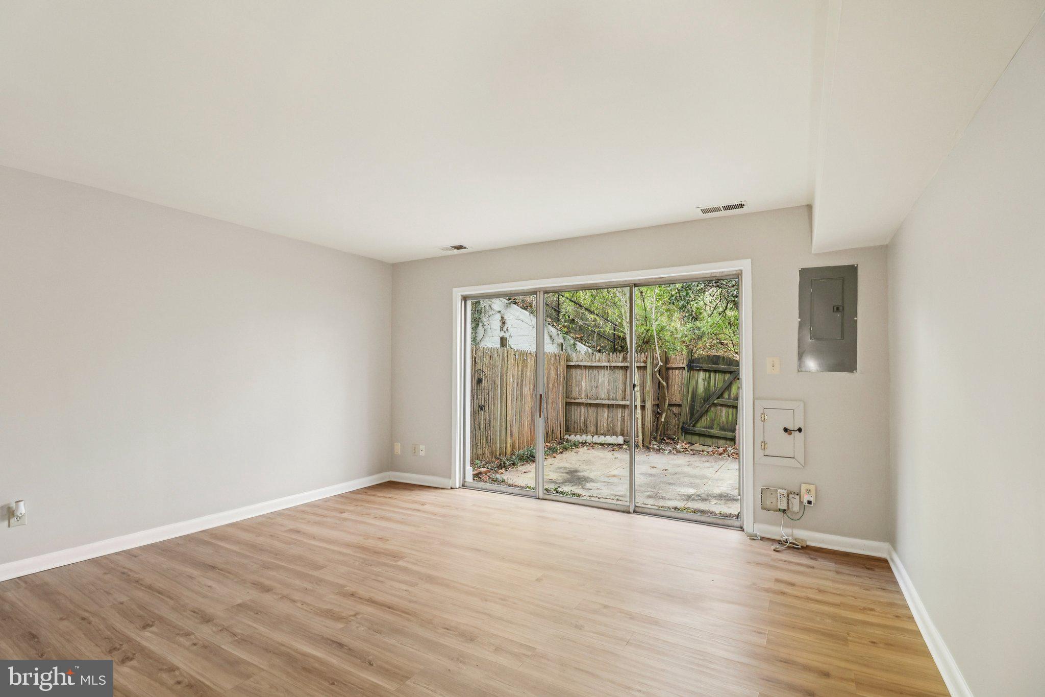 5912 Minutemen Road, Unit 295 Springfield, VA 22152 - Photo 25 of 55 an empty room with wooden floor and windows