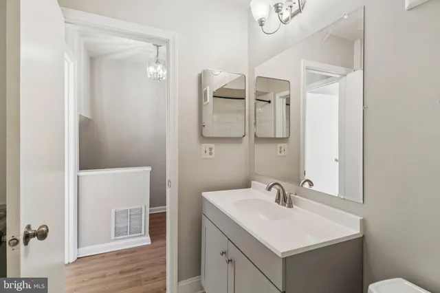 a view of a room with wooden floor and a ceiling fan