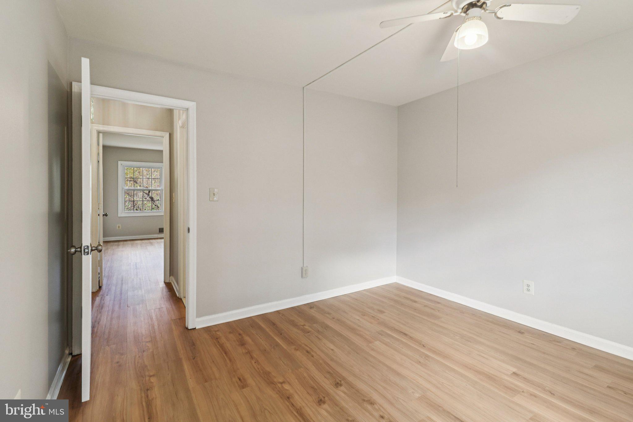 5912 Minutemen Road, Unit 295 Springfield, VA 22152 - Photo 35 of 55 a view of a room with wooden floor and a ceiling fan