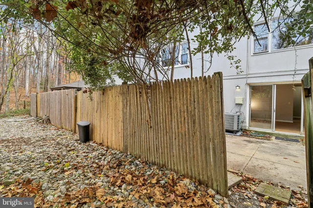 a view of a house with a door and wooden fence