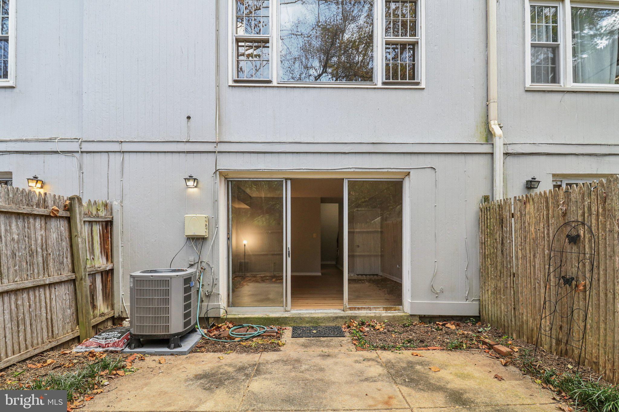 5912 Minutemen Road, Unit 295 Springfield, VA 22152 - Photo 39 of 55 a view of a house with a door and wooden fence