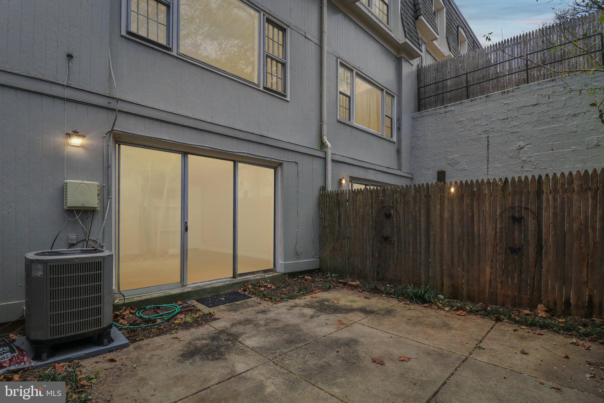 5912 Minutemen Road, Unit 295 Springfield, VA 22152 - Photo 41 of 55 a view of backyard with brick wall