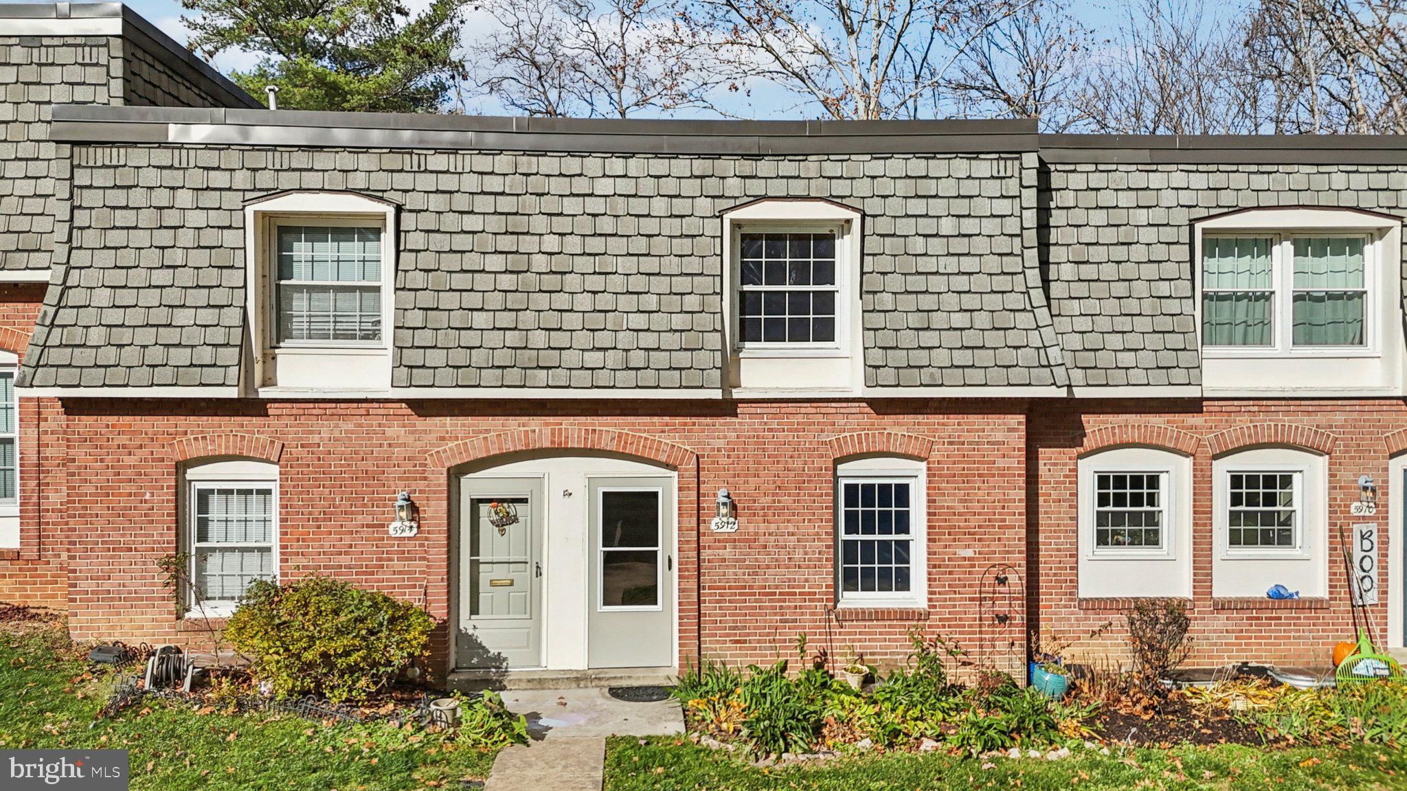 5912 Minutemen Road, Unit 295 Springfield, VA 22152 - Photo 43 of 55 front view of a brick house with large windows