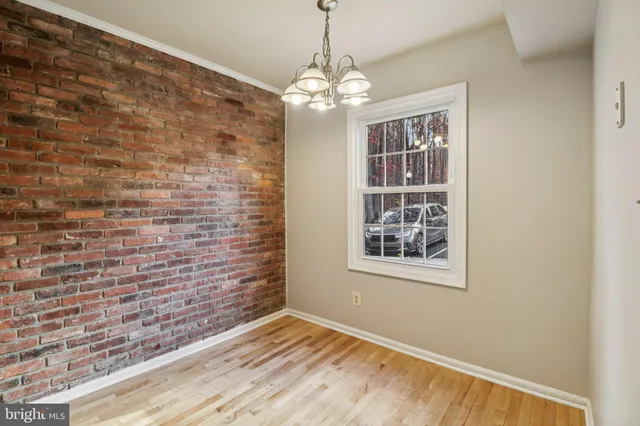 a view of a room with window wooden floor and chandelier