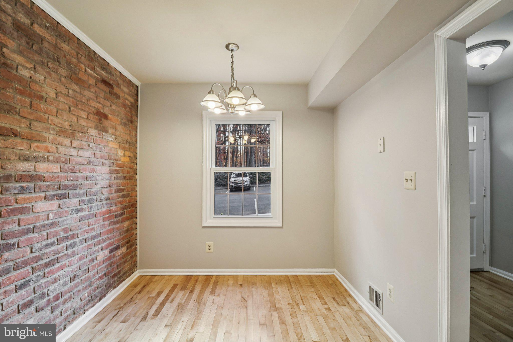5912 Minutemen Road, Unit 295 Springfield, VA 22152 - Photo 8 of 55 a view of a room with window wooden floor and chandelier