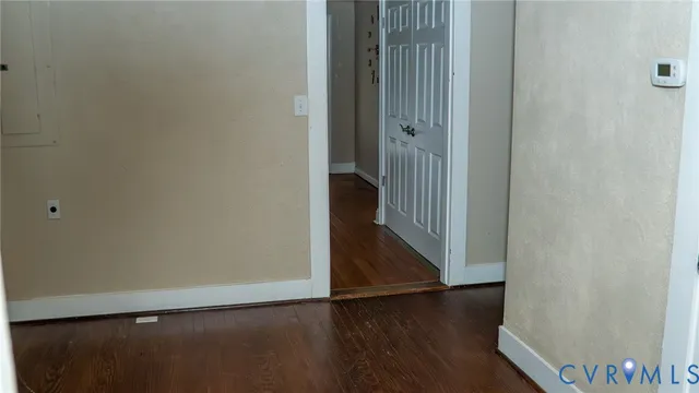 a view of a hallway with wooden floor
