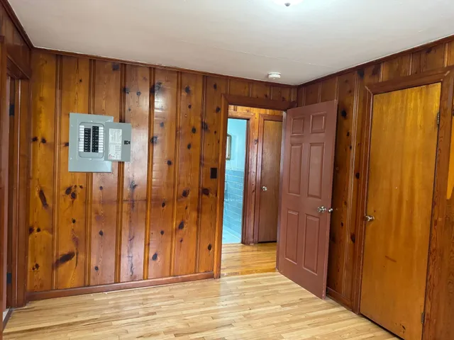 a view of a hallway with wooden shelves