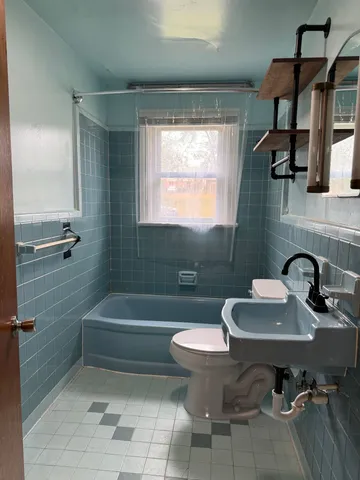 a bathroom with a sink a toilet and bathtub