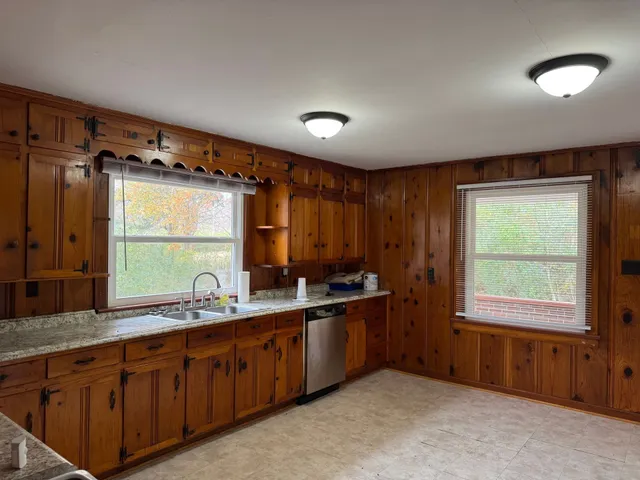 a bathroom with a double vanity sink a mirror and a bathtub
