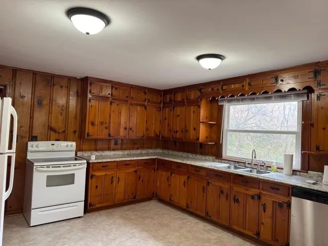 a kitchen with a sink stove and cabinets