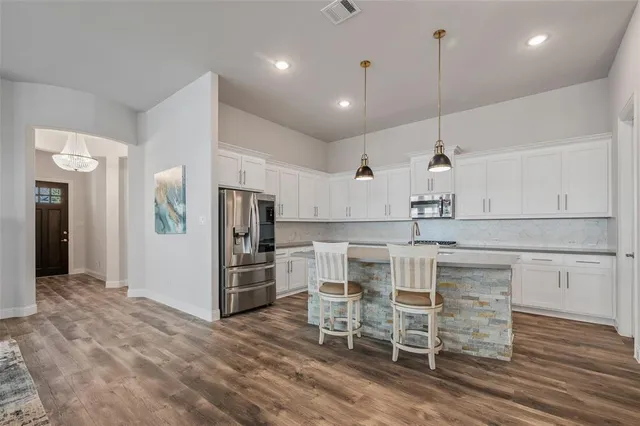 a large kitchen with a table and chairs in it