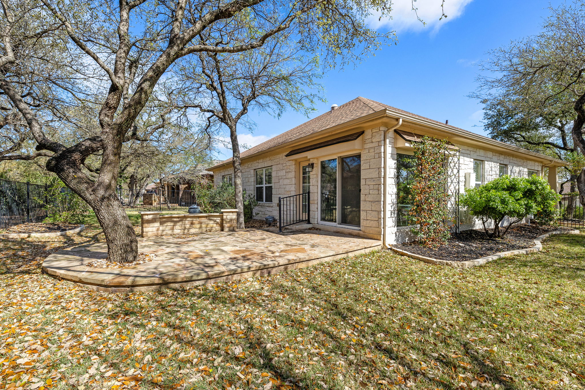5201 Big Spring Street Georgetown, TX 78633 - Photo 23 of 26 a view of a white house with a large tree and plants