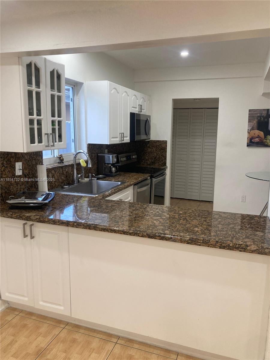 1671 Southwest 29th Avenue Miami, FL 33145 - Photo 11 of 21 a kitchen with sink a refrigerator and a counter top space