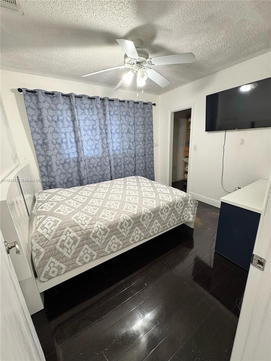 1671 Southwest 29th Avenue Miami, FL 33145 - Photo 12 of 21 a bedroom with a bed and a television