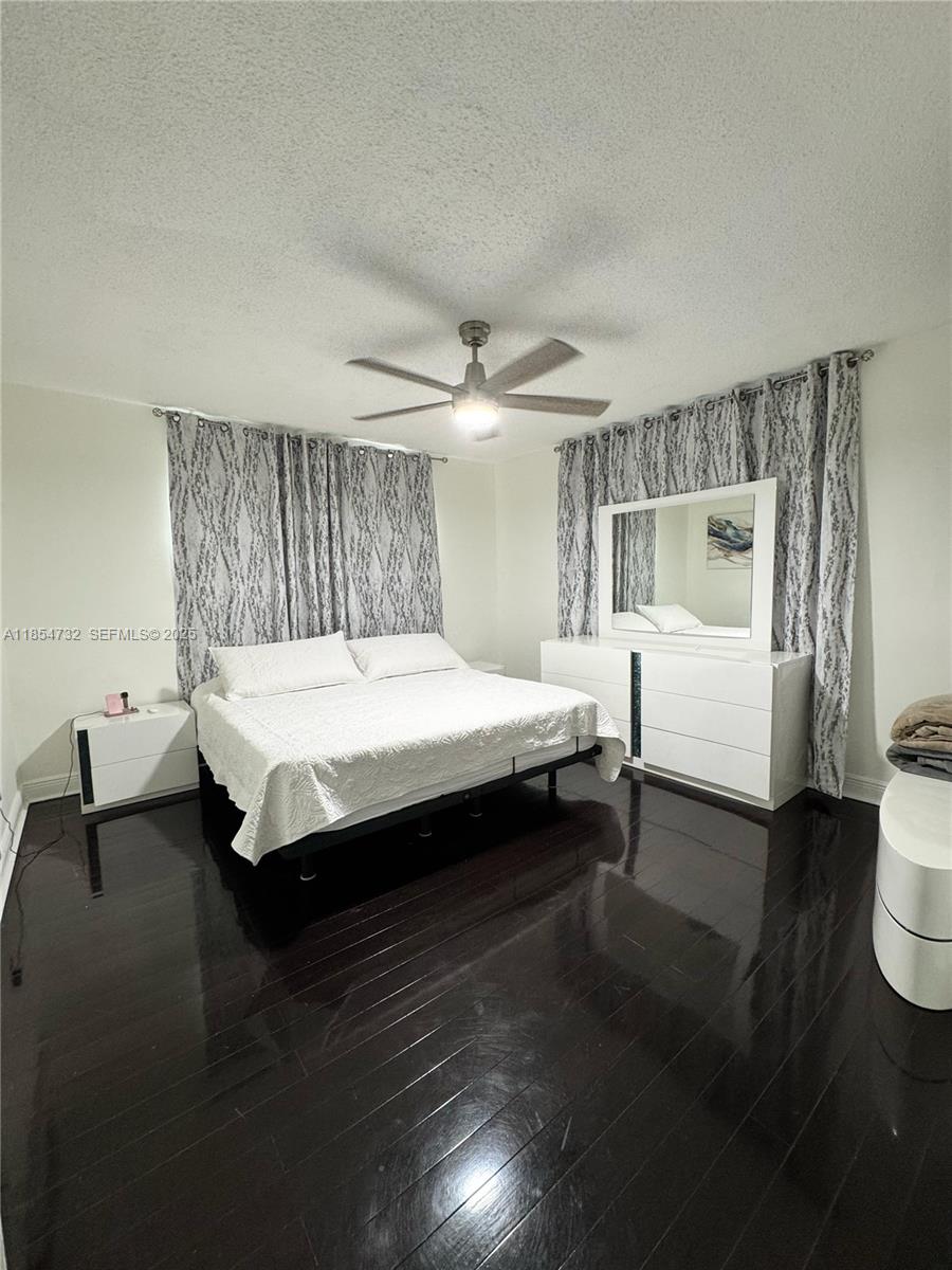 1671 Southwest 29th Avenue Miami, FL 33145 - Photo 13 of 21 a bedroom with a bed and wooden floor