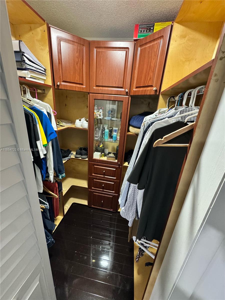 1671 Southwest 29th Avenue Miami, FL 33145 - Photo 16 of 21 a view of walk in closet with clothes and shoes