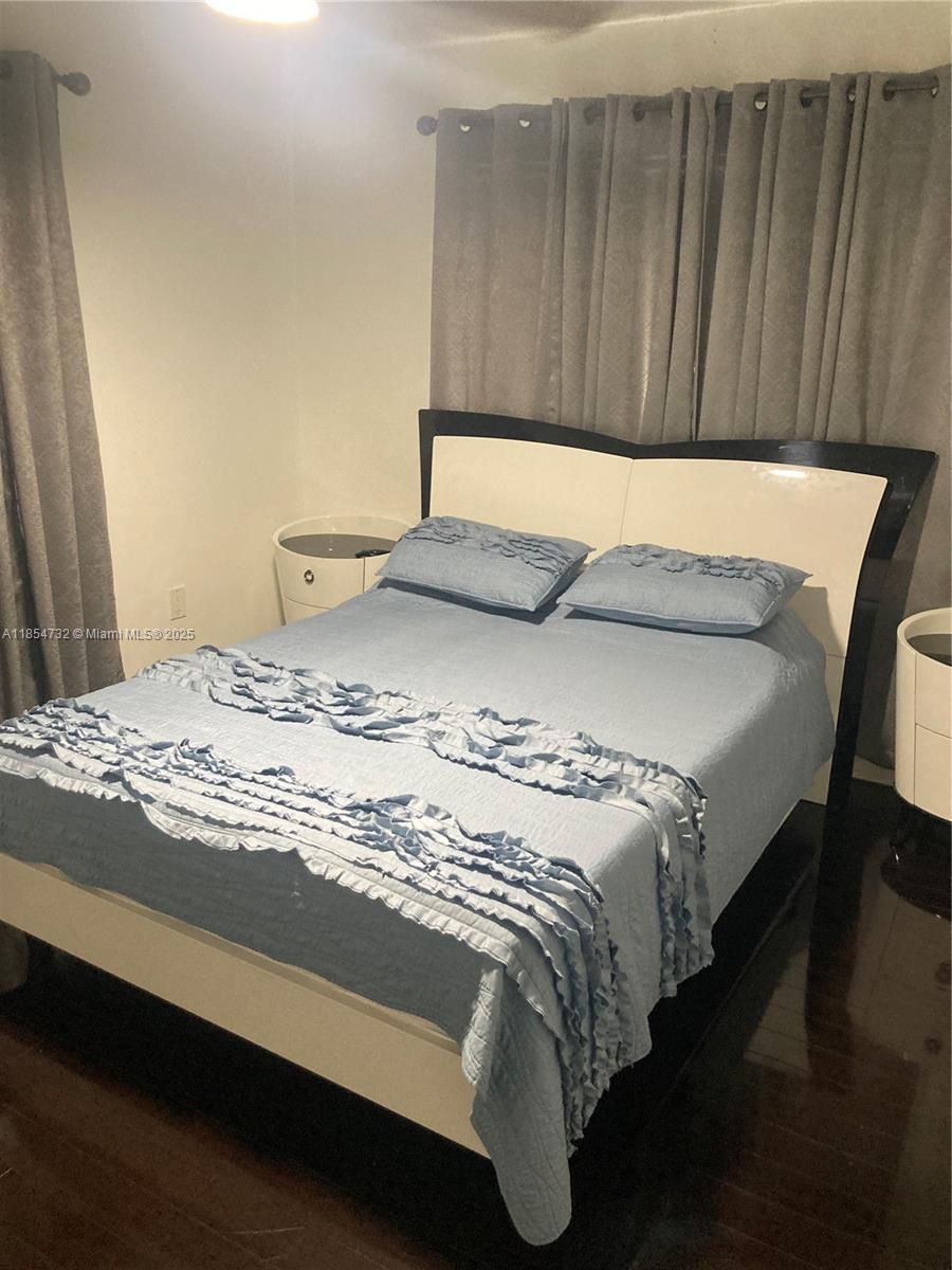 1671 Southwest 29th Avenue Miami, FL 33145 - Photo 21 of 21 a bed sitting in a bedroom next to a wooden cabinet