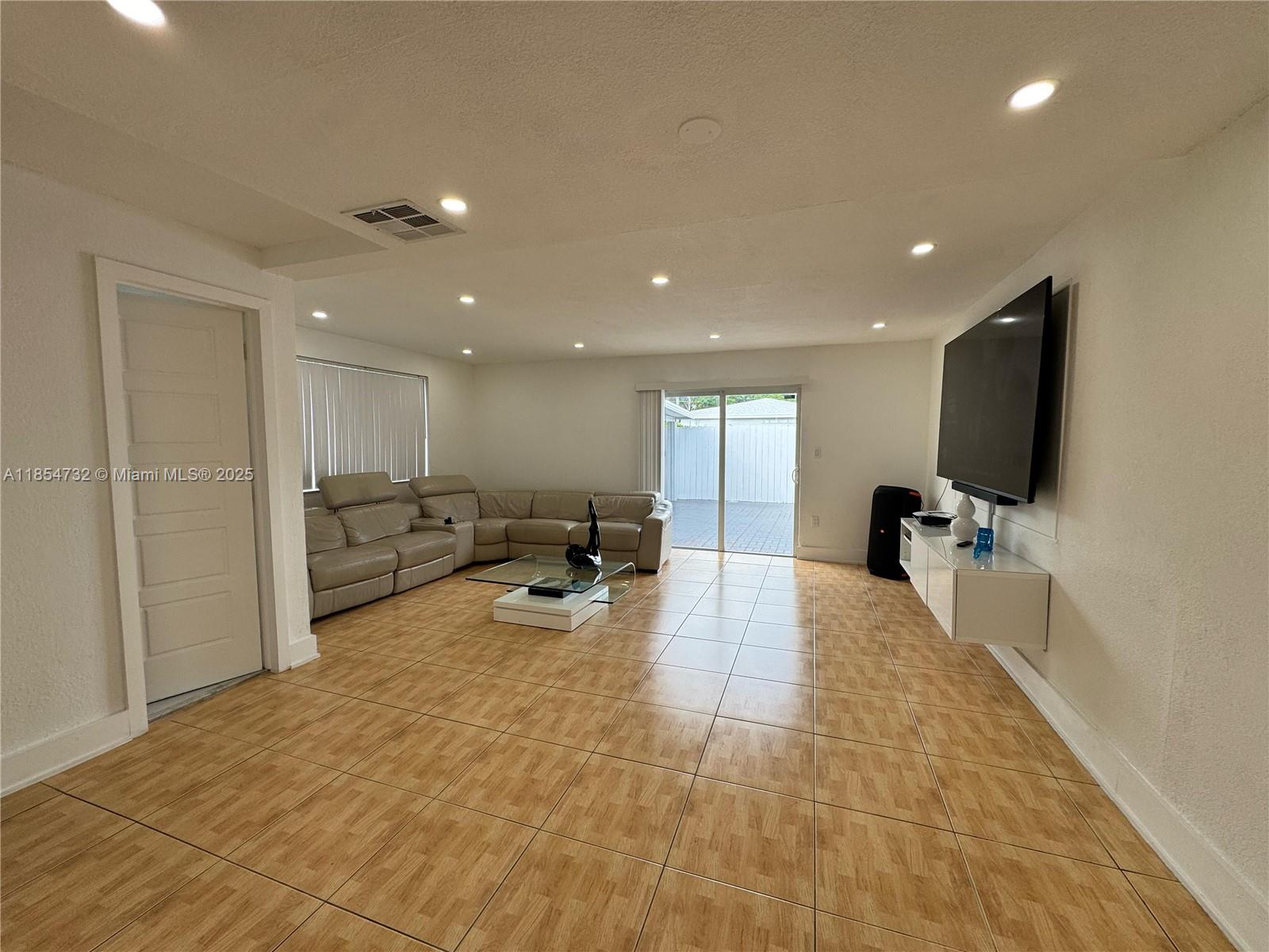 1671 Southwest 29th Avenue Miami, FL 33145 - Photo 6 of 21 a lobby with furniture and a flat screen tv