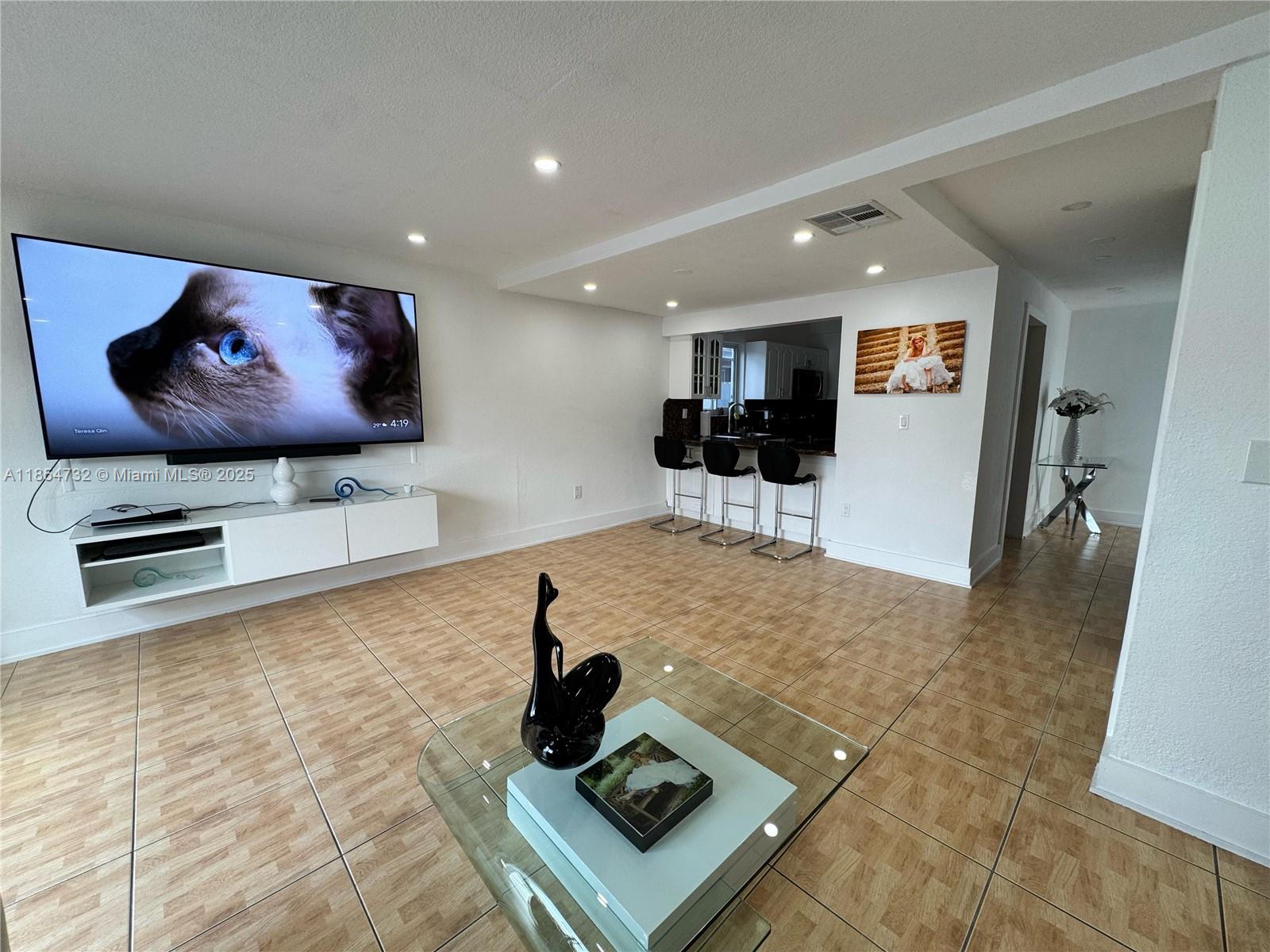 1671 Southwest 29th Avenue Miami, FL 33145 - Photo 7 of 21 a living room with furniture and a flat screen tv