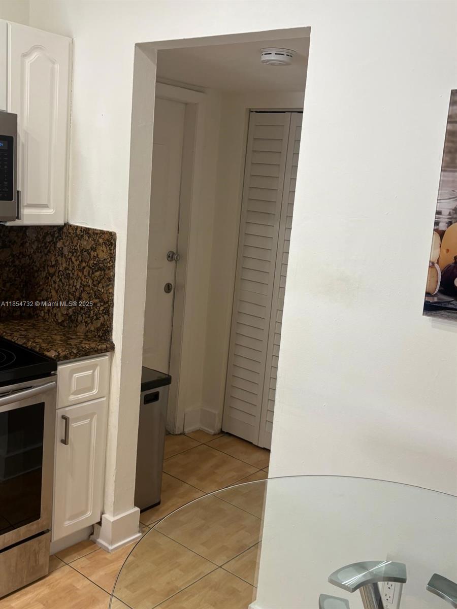 1671 Southwest 29th Avenue Miami, FL 33145 - Photo 9 of 21 a kitchen with a stove and a refrigerator