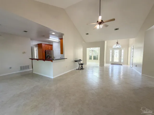 a view of a livingroom with a ceiling fan and a large window
