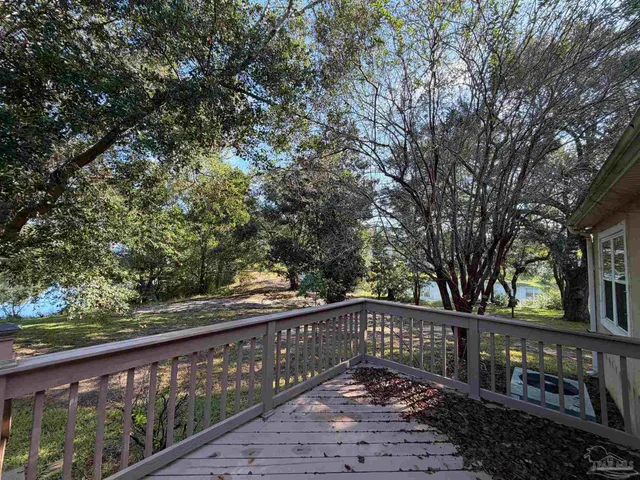 a view of a wooden deck next to a yard