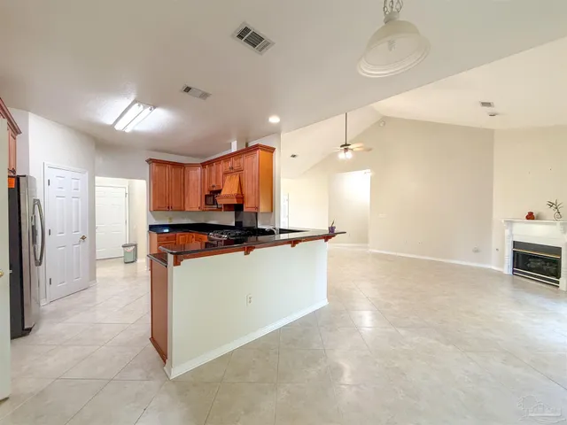 a view of kitchen with refrigerator and window