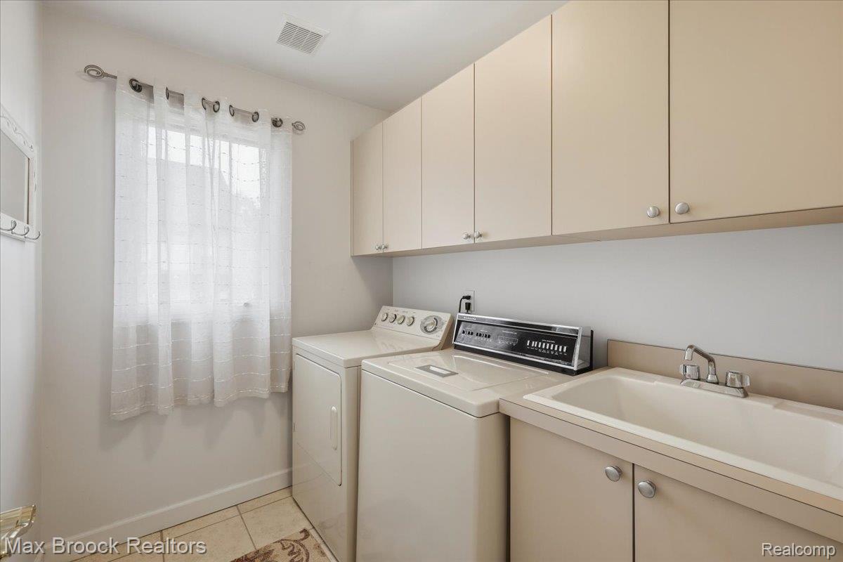 1731 Rico Road Commerce Township, MI 48382 - Photo 20 of 48 Laundry space featuring a utility sink, light-toned cabinetry, and tile flooring