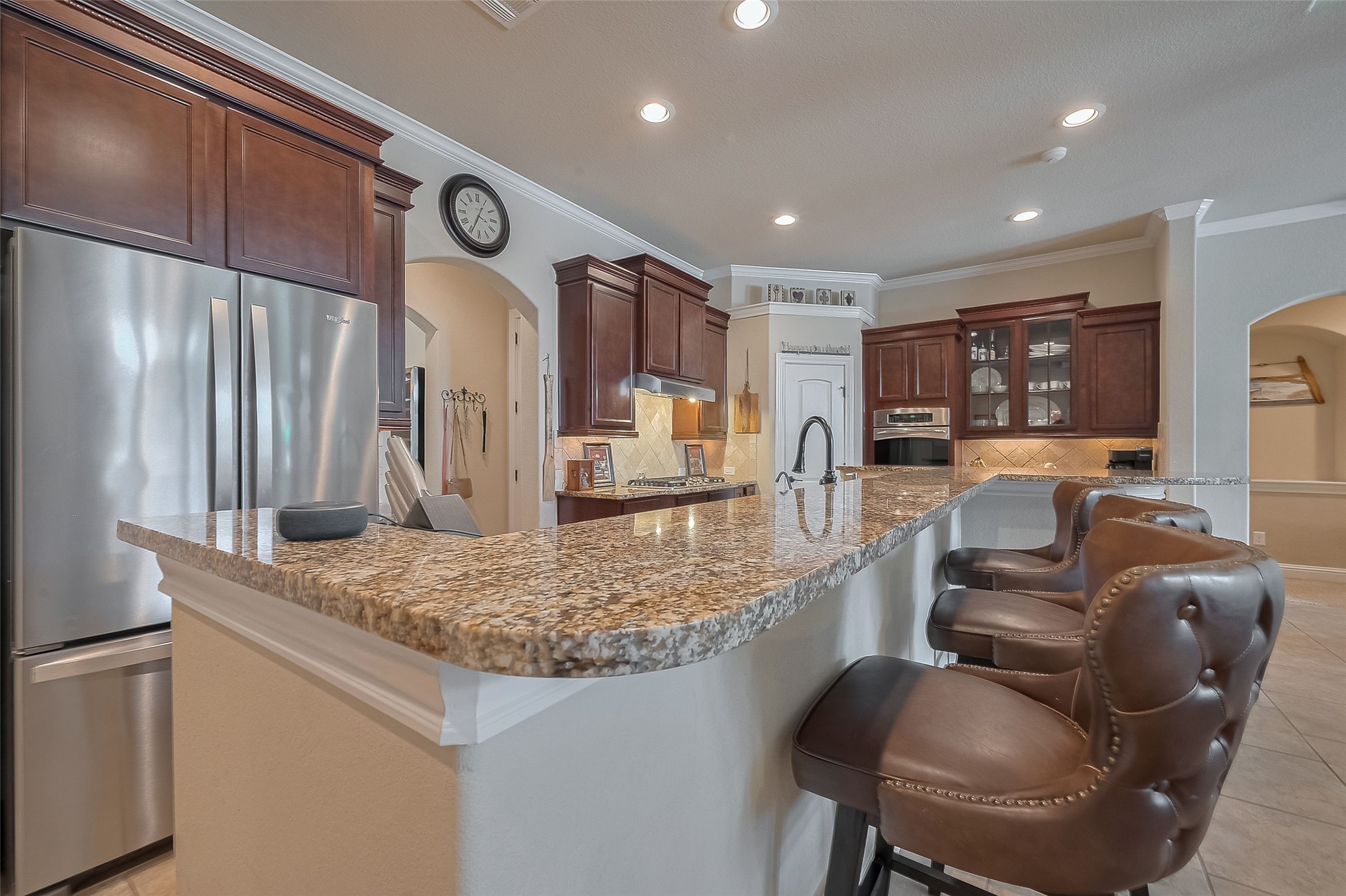 28210 Green Forest Bluff Trail Katy, TX 77494 - Photo 10 of 32 Breakfast bar seating, granite counters, and stainless steel appliances