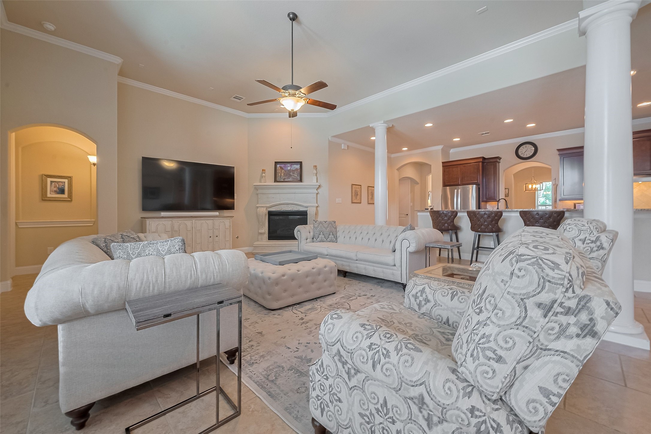 28210 Green Forest Bluff Trail Katy, TX 77494 - Photo 7 of 32 Cozy corner fireplace in the living room, beautiful wood columns, and elevated ceilings
