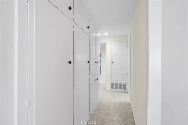 a front view of a house with a tree