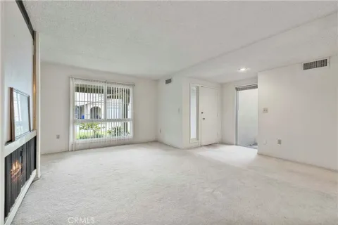 an empty room with windows and closet