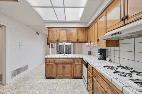 a kitchen with a stove sink and cabinets