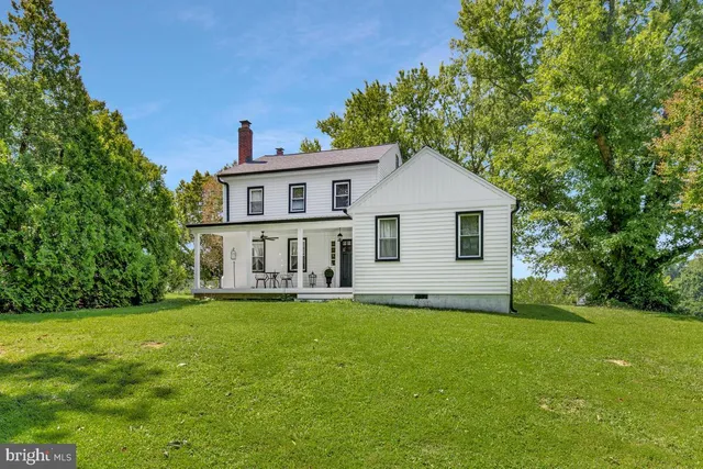 a view of a house with a yard and a porch