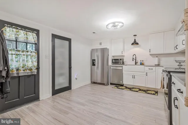 a view of a living room kitchen and a window